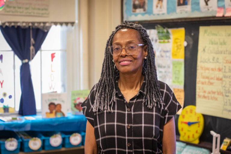 Cheryl Daniels, the Book Trust Teacher of the Year, smiles while standing in her classroom.